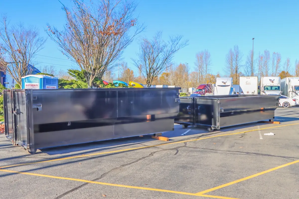 Professional dumpster rental service with roll-off container on residential driveway in Rochelle